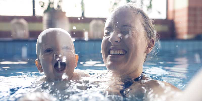 indoor-swimming-pool, parent and child swimming in indoor pool