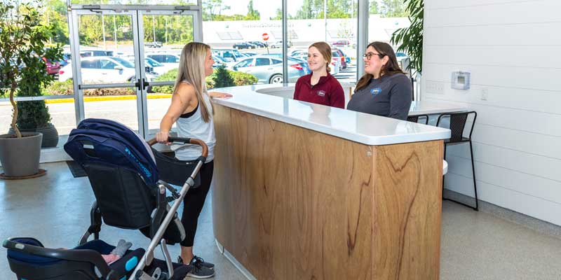 Woman with baby meeting Njswim teachers to inquire about swimming classes