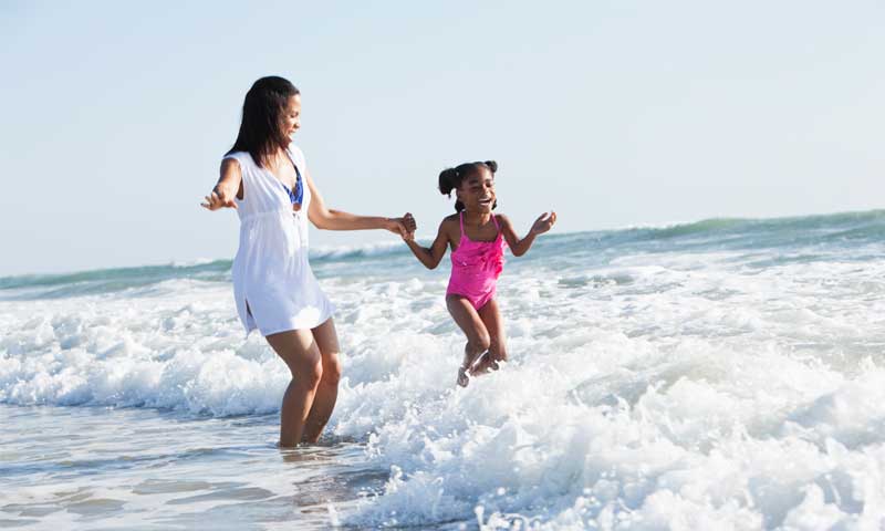 A mother and daughter stay safe in the ocean