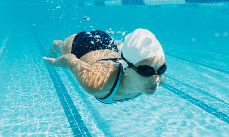 Swim student under water in swimming pool