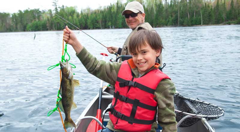 A father and son fishing in a canoe