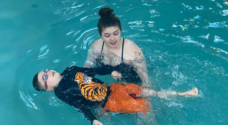 Njswim teacher and student in pool during a swim lesson