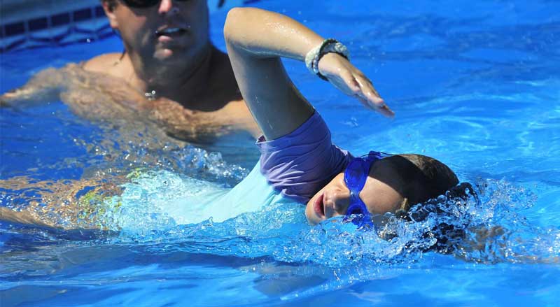 A swimming student taking Power Swim lessons